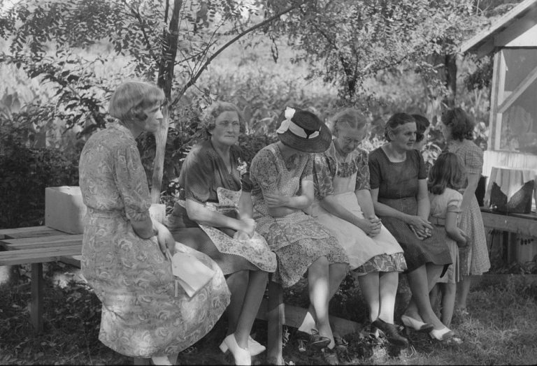 Parishioners of St. Thomas Church resting after preparing food for a benefit picnic supper
